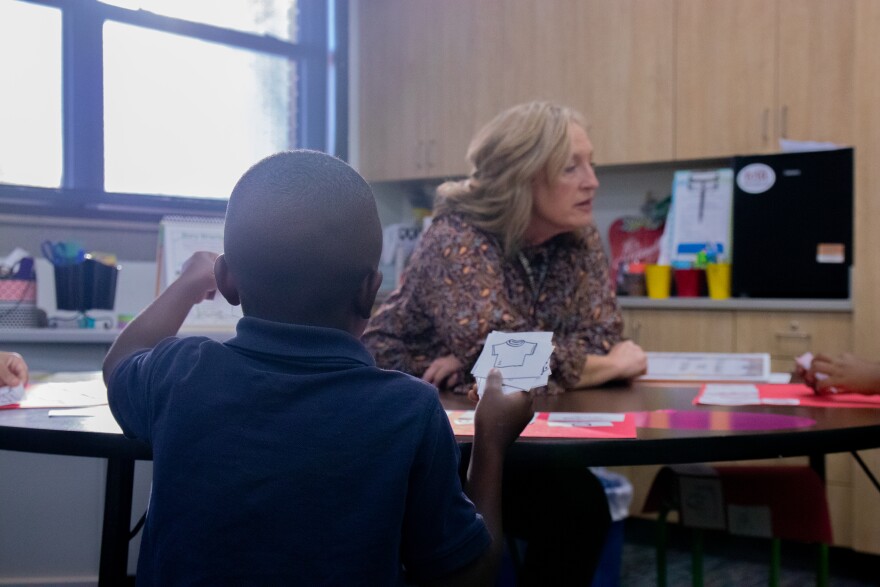 John Burroughs Elementary second grade teacher Vicky Caldwell helps a small group of students with similar reading levels identify sounds in words.