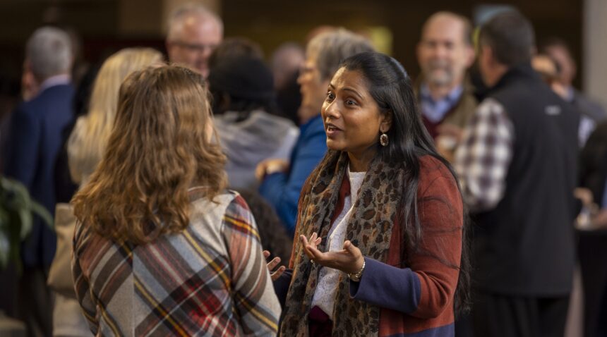 A photo of two women talking outside Rudder Theatre prior to the State of the University address.